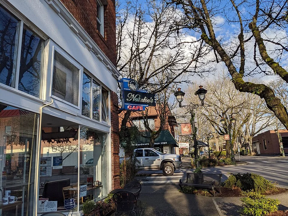 Tree-lined NE 4th Avenue in downtown Camas, Washington with historic storefronts